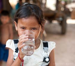 girl drinking a glass of water